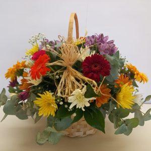 colourful mixed flowers in a basket babsi george delivery