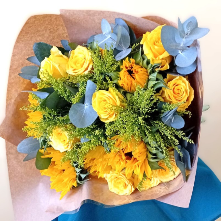 A bouquet of yellow roses and sunflowers with green eucalyptus and foliage