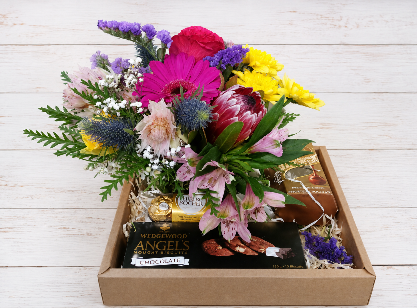 Small Seasonal Flower posy accompanied by Lindt Assorted 75g, Angel Biscuits 150g and Ferrero Rocher T3
