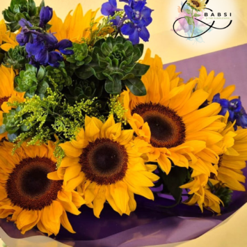 Ray of Sunshine bouquet featuring large yellow sunflowers, deep blue delphiniums, Carthamus and golden rod