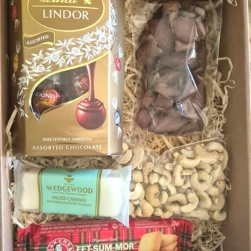 Weekend Snack Box with Lindt chocolates, biltong, nuts, nougat and shortbread biscuits beautifully packaged for sweet and savory gifting.