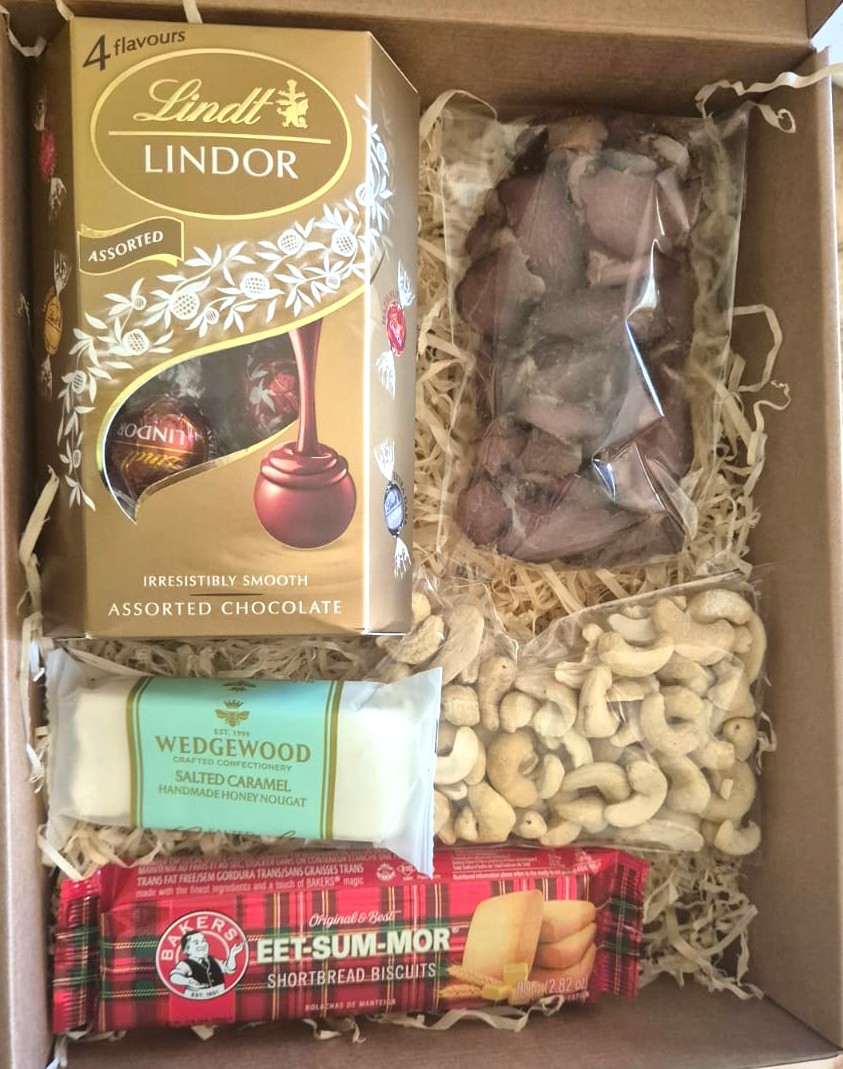 Weekend Snack Box with Lindt chocolates, biltong, nuts, nougat and shortbread biscuits beautifully packaged for sweet and savory gifting.